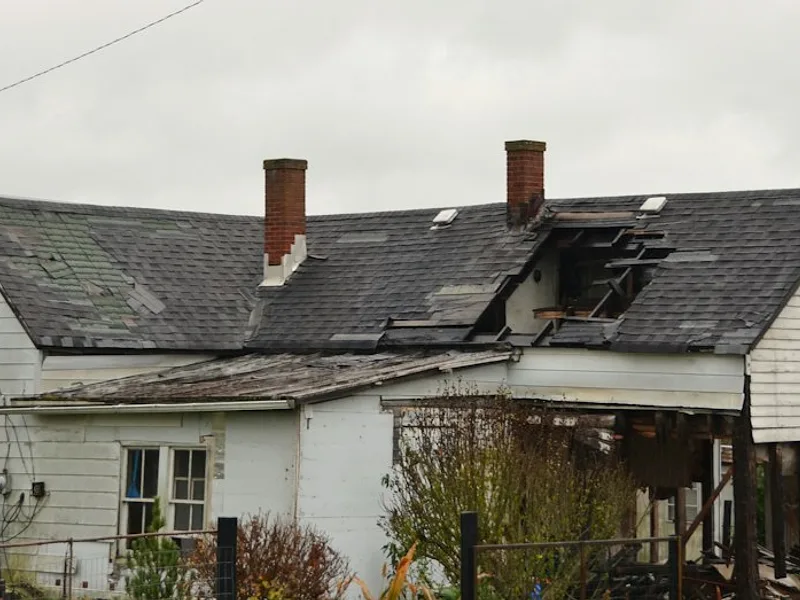 Dilapidated house with a damaged roof