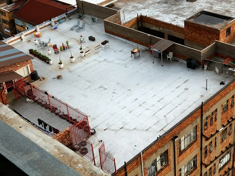 an aerial view of a building with a roof covered in snow