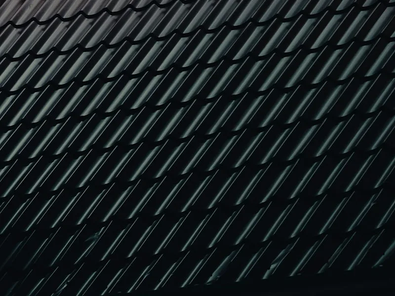 a close up of a building with a black roof